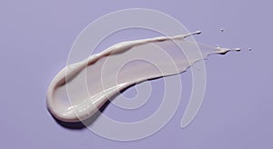 Textured Off-White Cosmetic Cream Swirl on Lavender Background photo