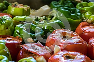 Close-up of stuffed peppers and tomatoes - greek gemista placed on an oven tray.