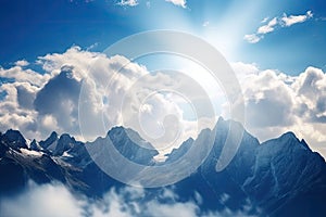 close-up of stunning mountain range with clouds, sun, and blue skies