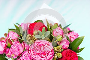 Close up of stylish bouquet of pink and red roses with a blank g