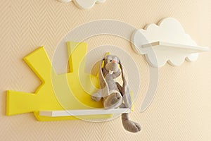 Close-up Stylish and modern Interior design. Home for the child room. Children`s shelves in the form of white clouds on a plain