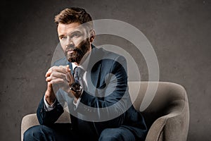 close up of successful businessman sitting in armchair with