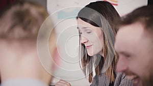 Close-up of successful confident businesswoman talking to multiethnic workers at company team training seminar session.