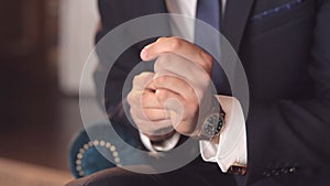 Close-up of a successful man is putting on a wristwatch. Men