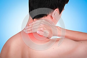 Close up suffering male pain in neck on blue background.