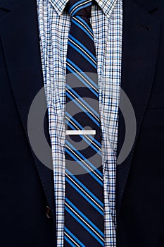 Close up of suit and tie with tie clip
