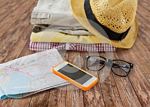 Close up of summer clothes and travel map on floor