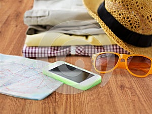 Close up of summer clothes and travel map on floor