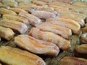 Close up sun dried banana on threshing basket. thai traditional food