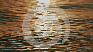 Close up. Sun Reflections At Water Surface. Beautiful Defocused Abstract Blurry Sea Water Background.