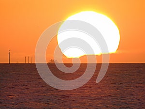 Close up of sun with ship silhouette at Portsmouth West Sussex