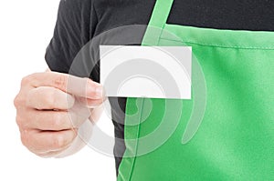 Close-up of supermarket employee showing business card