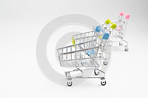 Close up of supermarket grocery push cart for shopping with black wheels on white background. Concept of shopping.