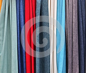 Close up surface of colorful fabrics cloth and textiles being folded and hang up in high resolution