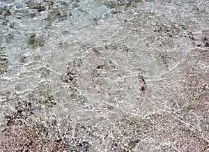 Close up surface of floating water with ripples and waves and some reflections