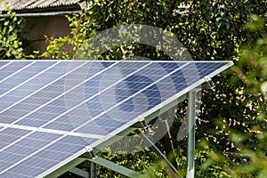 Close-up surface of lit by sun modern saving efficient stand -alone blue shiny solar photo voltaic panels system producing