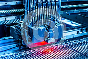 Close-up surface-mounting machine in progress.