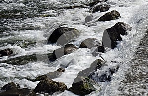 Close up of the surging stream in a mountain stream