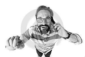 Close up of surprised bearded man smiling with mobile phone and pointer finger