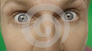 Close-up of a surprised emotional man with blue eyes looking into the camera