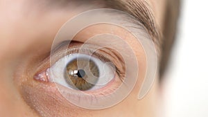 Close-up of a surprised emotional man with brown eye