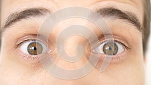 Close-up of a surprised emotional man with brown eyes