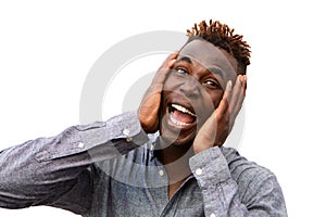 Close up surprised young african man with hands on face over white background