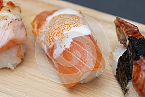 Close - up of sushi salmon in plate on stone table