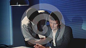 Close-up of suspected man forced to recognize the person in the photo during interrogation room