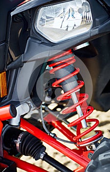 Close-up of suspension elements on an all-wheel drive ATV