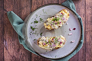 Close up of swedish salad with anchovies, potatoes and egg on rye bread on a plate top view