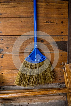 Close-up of sweeping broom on wooden wall