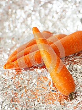 close up of sweet orange carrots over a tin paper