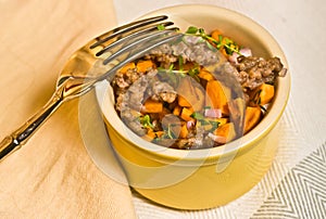 Close up of sweet potato home fries and pork breakfast, paleo diet