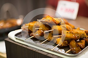 Close up of a sweet potatoes brochette, street food at Nishiki Market, Kyoto, Japan