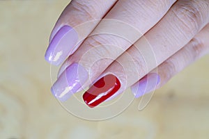 Close up sweet shiny baby violet and dark red colr gel polish painting on long square shape woman fingernail
