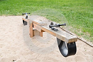 Close up of swing or teeterboard on playground