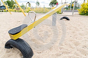 Close up of swing or teeterboard on playground photo