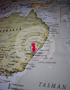 Close up of Sydney pin pointed on the world map with a pink pushpin