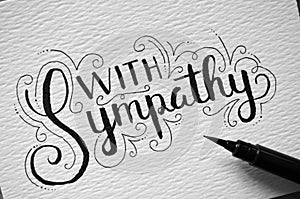 Close-up of `WITH SYMPATHY` hand-lettered on card