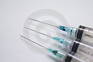 Close up of a syringe selective focus on needle, isolated on white background