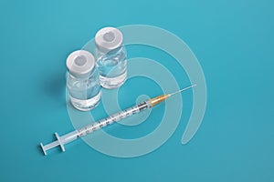Close-up Syringe with two ampules on blue background