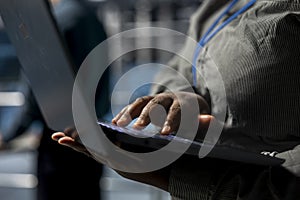 Close up of system administrator in data center using laptop