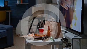 Close up of table with food and booze leftover on misery table photo