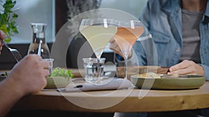 Close-up of a table with food in a cafe. Unrecognizable man and woman in a restaurant, lunch with various vegetarian