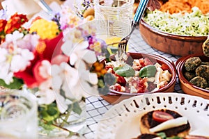 Close up of table full of fresh seasonal healthy food for group of people - lunch or brunch background coloured composition