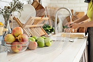Close up of table with green vegetables and fresh fruit in the kitchen