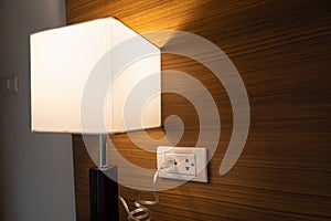 Close Up table lamp electrical power socket and plug socket on wall