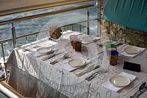 close up of table setting at open-air restaurant on beach