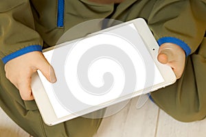 Close-up of a tablet with a child& x27;s hands